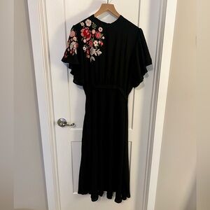 Floral embroidered black dress with back tie and slit.